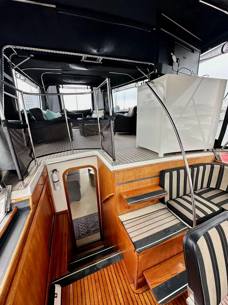 Slide: The Image of Interior view of 1985 Gulfstar 49 Motor Yacht with wooden stairs and seating. - 43