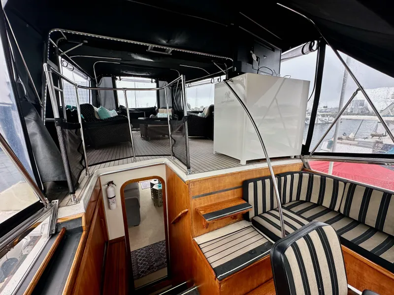 Slide: The Image of 1985 Gulfstar 49 Motor Yacht interior with striped seating and spacious lounge area. - 44