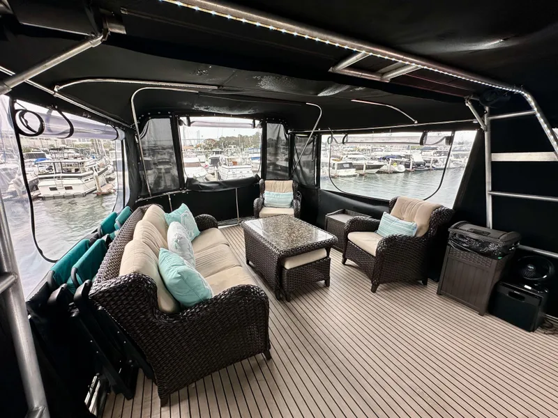 Slide: The Image of Luxurious 1985 Gulfstar 49 Motor Yacht interior with comfortable seating and marina view. - 47