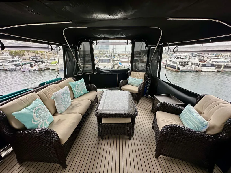 Slide: The Image of Luxurious 1985 Gulfstar 49 Motor Yacht interior with elegant seating and marina view. - 48