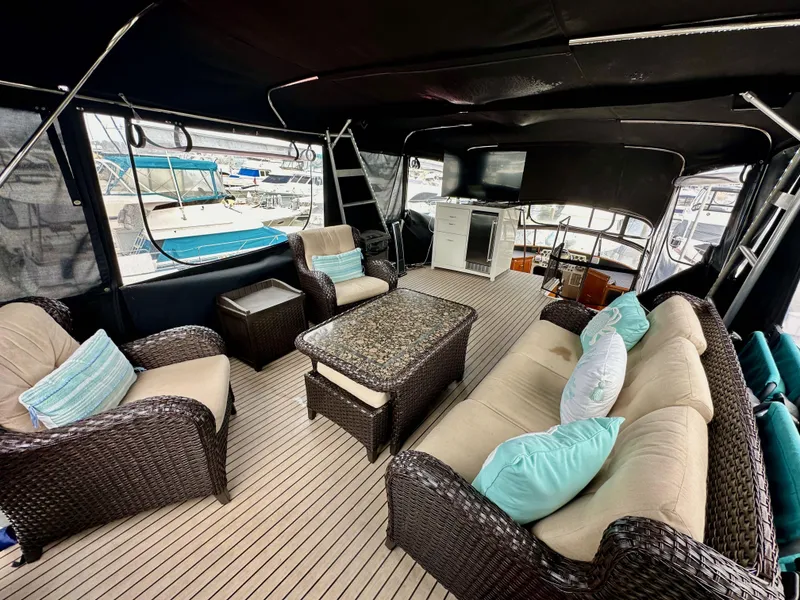 Slide: The Image of Luxurious 1985 Gulfstar 49 Motor Yacht interior with wicker furniture and elegant decor. - 49