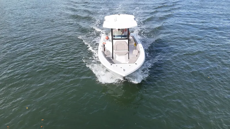 Slide: The Image of 2023 Sea Pro 239 Deluxe CC boat cruising on open water. - 11