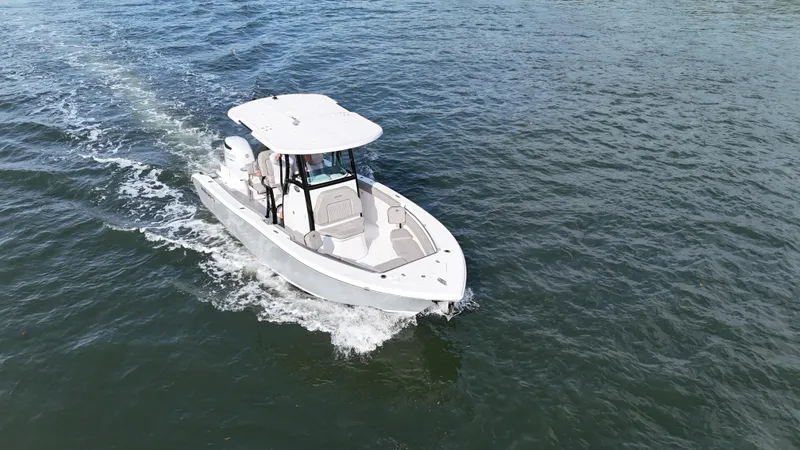 Slide: The Image of 2023 Sea Pro 239 Deluxe CC boat cruising on open water. - 12