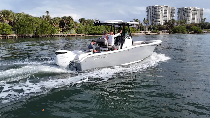Slide: The Image of 2023 Sea Pro 239 Deluxe CC boat cruising on a scenic waterway. - 13