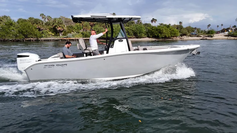 Slide: The Image of 2023 Sea Pro 239 Deluxe CC boat cruising on a scenic waterway. - 16