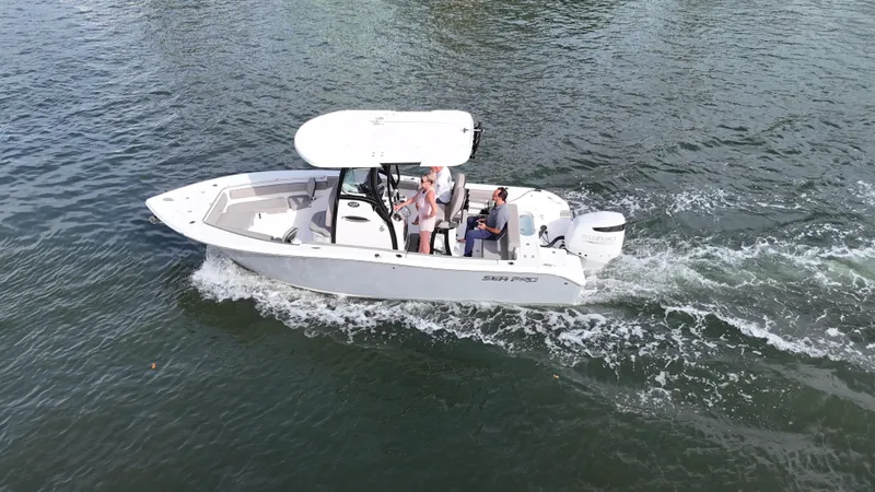 Slide: The Image of 2023 Sea Pro 239 Deluxe CC boat cruising on open water. - 2