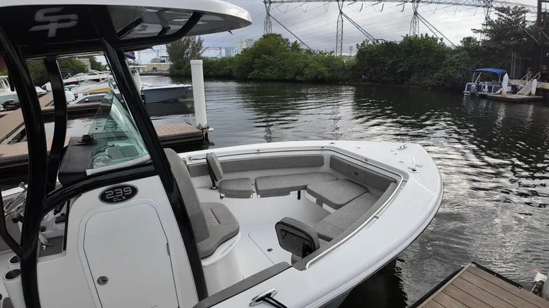 Slide: The Image of 2023 Sea Pro 239 Deluxe CC boat docked by a serene waterway. - 20