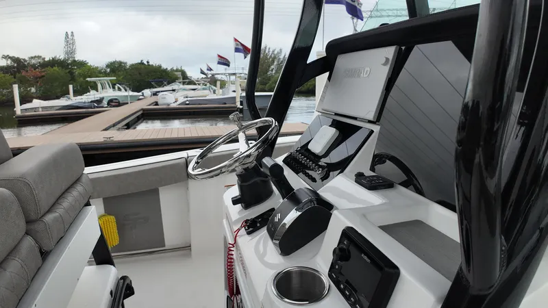 Slide: The Image of 2023 Sea Pro 239 Deluxe CC boat interior with steering wheel and control panel. - 22