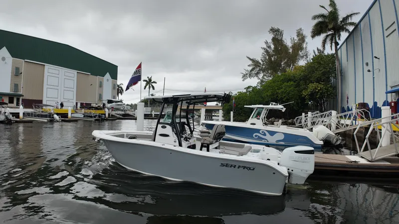 Slide: The Image of 2023 Sea Pro 239 Deluxe CC boat docked near marina with overcast sky. - 30