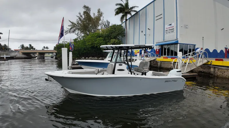 Slide: The Image of 2023 Sea Pro 239 Deluxe CC boat docked near a marina building. - 31