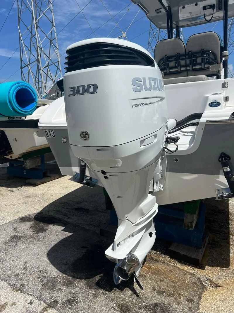 Slide: The Image of 2023 Sea Pro 239 Deluxe CC with Suzuki 300 outboard motor, docked outdoors. - 32