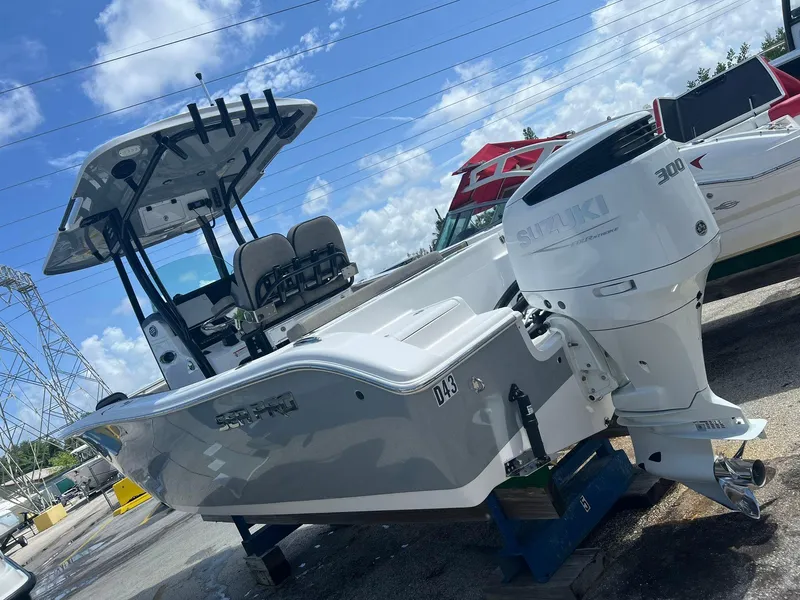 Slide: The Image of 2023 Sea Pro 239 Deluxe CC boat with Suzuki 300 engine, displayed outdoors. - 34