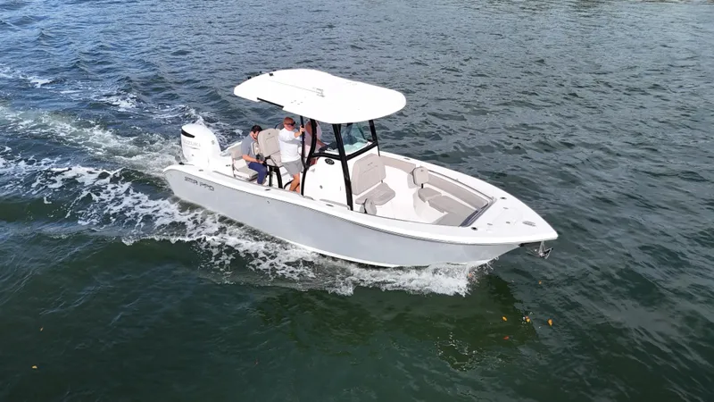 Slide: The Image of 2023 Sea Pro 239 Deluxe CC boat cruising on open water. - 5
