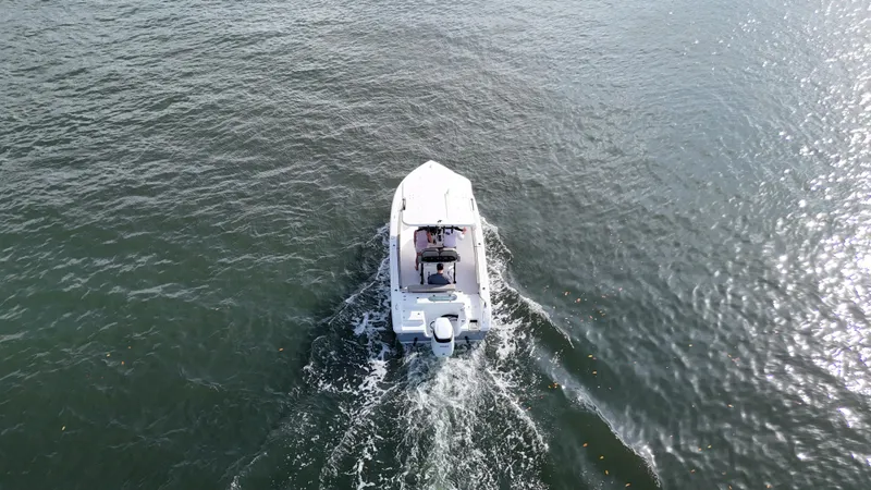 Slide: The Image of Aerial view of 2023 Sea Pro 239 Deluxe CC boat cruising on open water. - 6
