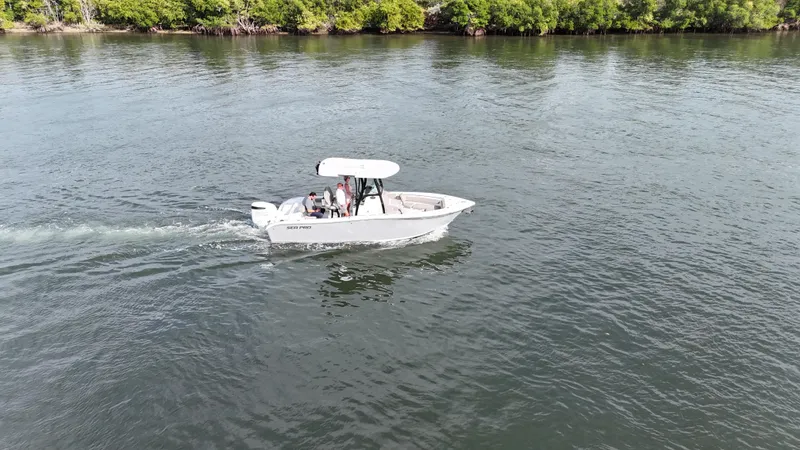 Slide: The Image of 2023 Sea Pro 239 Deluxe CC boat cruising on a calm river. - 7