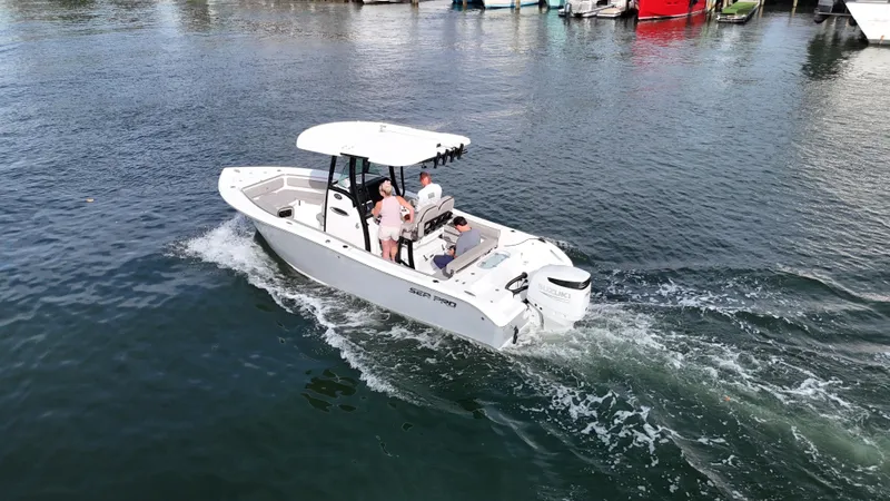 Slide: The Image of 2023 Sea Pro 239 Deluxe CC boat cruising on a calm waterway. - 8