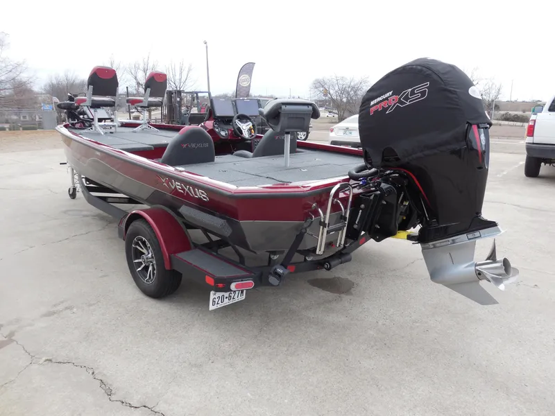 Slide: The Image of 2023 Vexus AVX1980 boat with motor, parked on a trailer in a lot. - 4