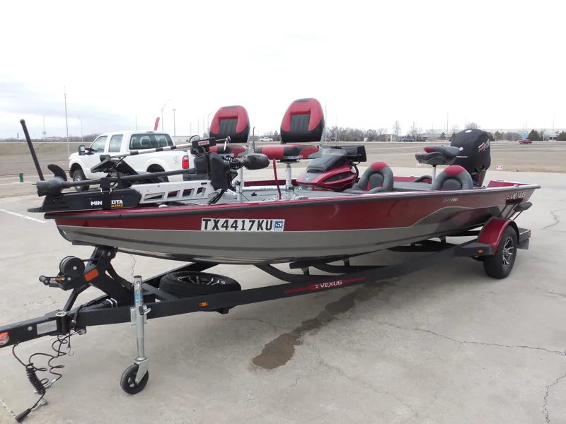 Slide: The Image of 2023 Vexus AVX1980 boat on trailer, red and black design, parked in a lot. - 5