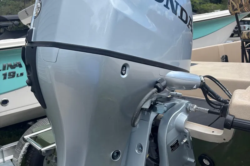 Slide: The Image of 2025 Carolina Skiff E18 JVX CC with Honda outboard motor, close-up view. - 5