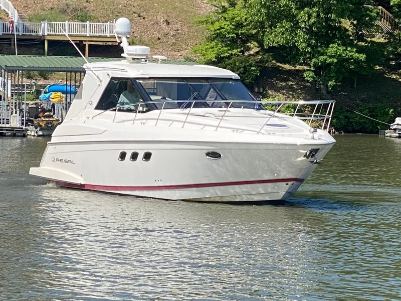 The Image of 2012 Regal 42 Sport Coupe yacht cruising on a calm lake. - 0