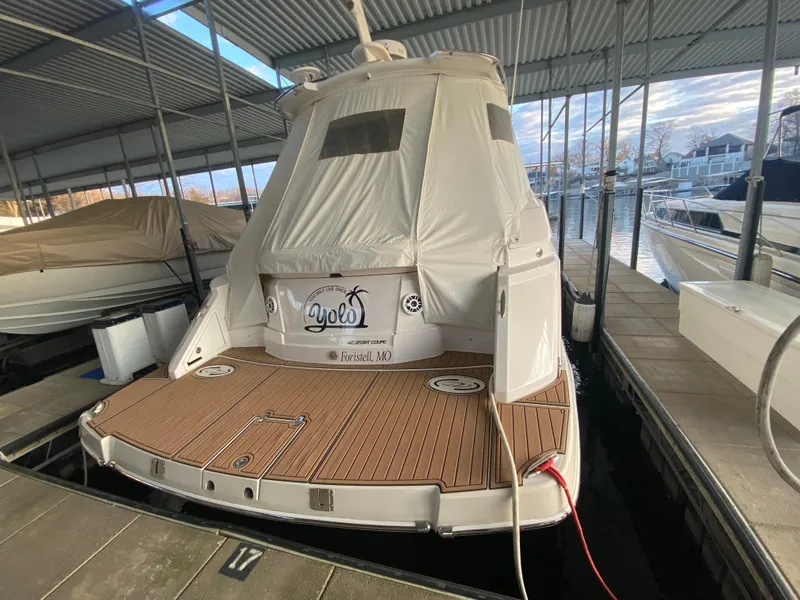 Slide: The Image of 2012 Regal 42 Sport Coupe docked under a covered marina. - 10