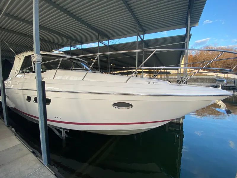 Slide: The Image of 2012 Regal 42 Sport Coupe docked under a covered marina. - 11