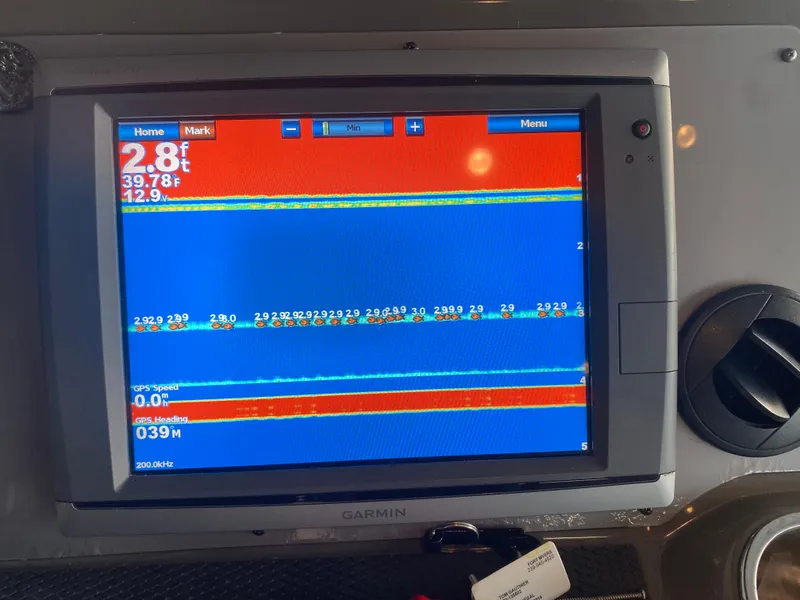 Slide: The Image of Garmin marine display on 2012 Regal 42 Sport Coupe showing depth and temperature data. - 25