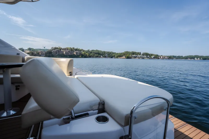 Slide: The Image of Luxurious 2012 Regal 42 Sport Coupe yacht on serene lake with scenic view. - 22