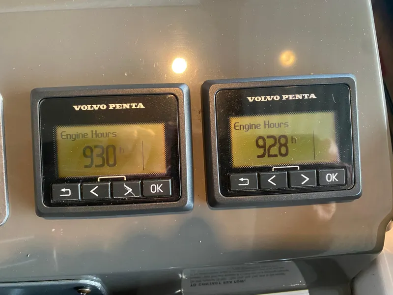 Slide: The Image of Volvo Penta engine hour meters showing 930 and 928 hours on a 2012 Regal 42 Sport Coupe. - 27