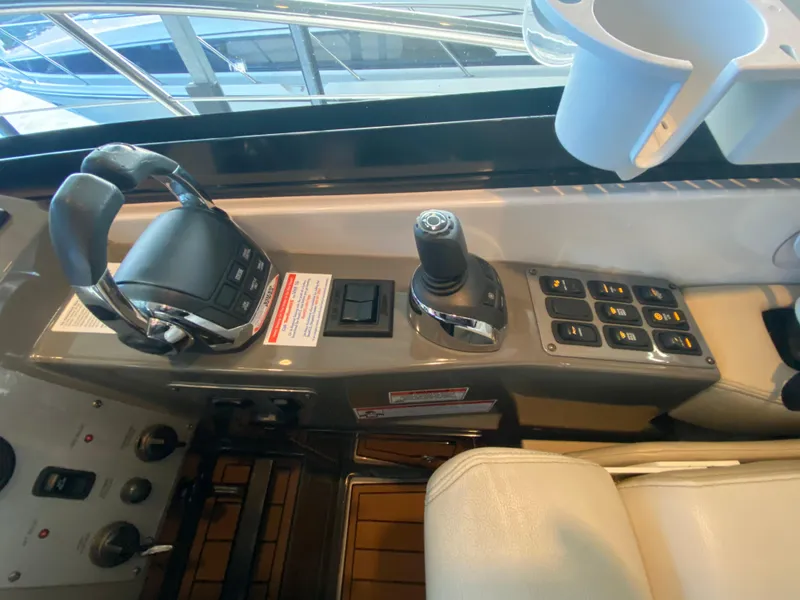 Slide: The Image of Control panel of a 2012 Regal 42 Sport Coupe yacht with joystick and throttle. - 28