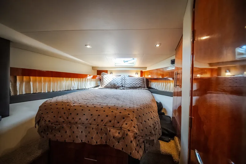 Slide: The Image of Luxurious cabin interior of 2012 Regal 42 Sport Coupe yacht with cozy bedding. - 52