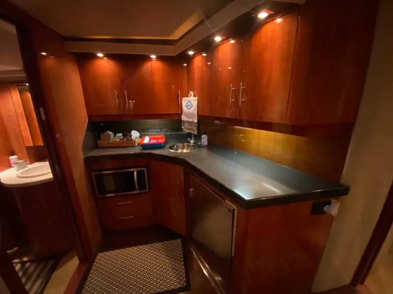 Slide: The Image of Luxurious 2012 Regal 42 Sport Coupe yacht interior kitchen with wood cabinetry and modern appliances. - 37