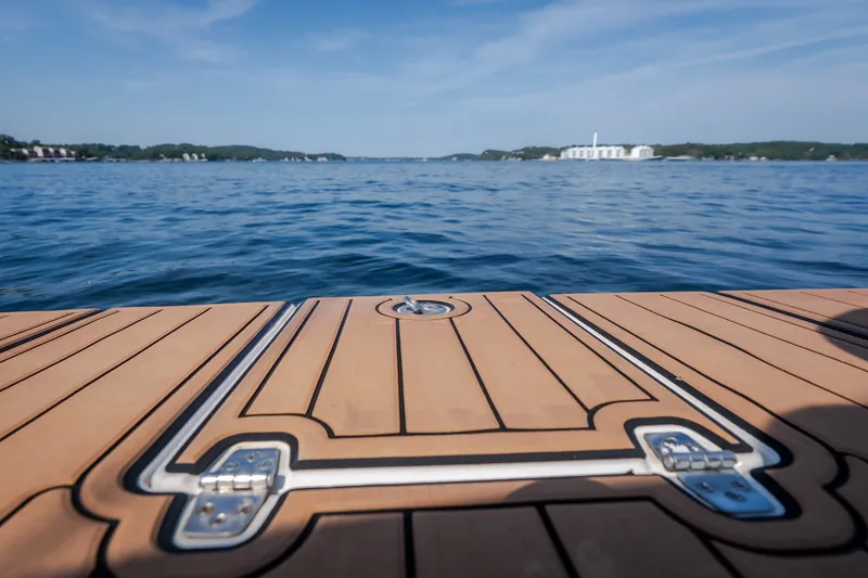 Slide: The Image of Teak deck of 2012 Regal 42 Sport Coupe overlooking serene lake view. - 16