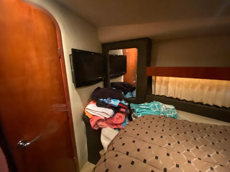 Slide: The Image of 2012 Regal 42 Sport Coupe yacht kitchen with microwave, sink, and stainless steel fridge. - 39