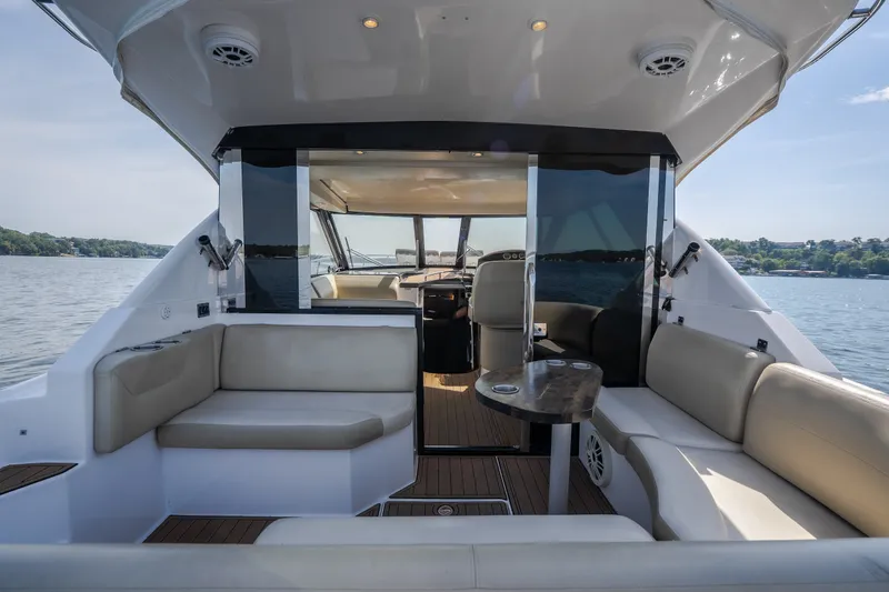 Slide: The Image of 2012 Regal 42 Sport Coupe yacht interior with spacious seating and scenic water view. - 18