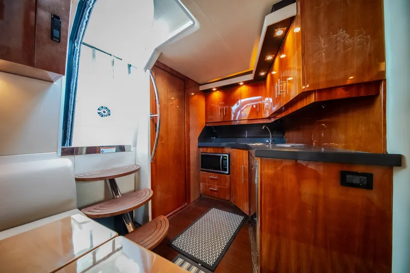 Slide: The Image of Luxurious interior of 2012 Regal 42 Sport Coupe yacht with modern kitchen amenities. - 50