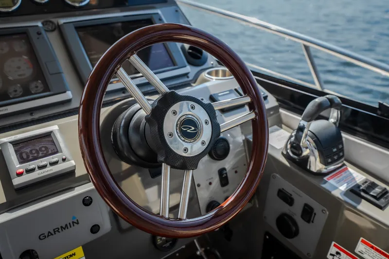 Slide: The Image of 2012 Regal 42 Sport Coupe helm with Garmin navigation system and wooden steering wheel. - 30