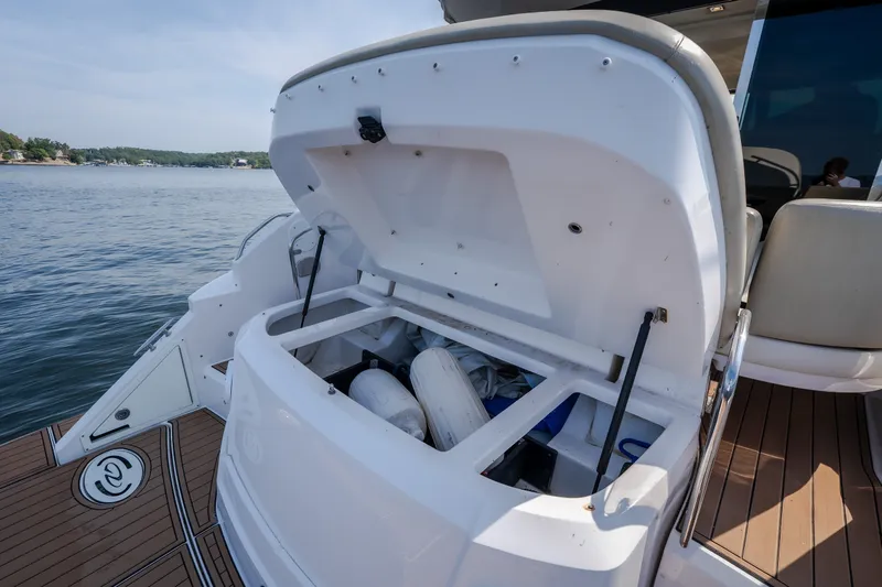 Slide: The Image of 2012 Regal 42 Sport Coupe boat with open storage compartment on deck. - 15