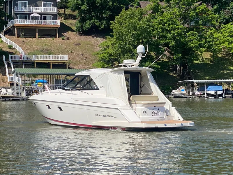 Slide: The Image of 2012 Regal 42 Sport Coupe yacht cruising on a serene lake. - 6