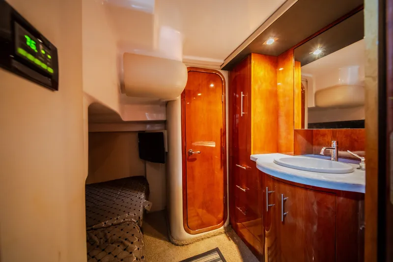 Slide: The Image of Luxurious interior of 2012 Regal 42 Sport Coupe yacht with wood cabinetry and modern amenities. - 56
