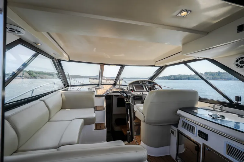 Slide: The Image of Luxurious interior of 2012 Regal 42 Sport Coupe yacht with panoramic windows and plush seating. - 64