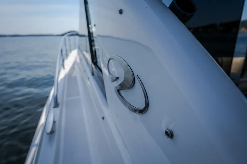Slide: The Image of 2012 Regal 42 Sport Coupe yacht on calm water, showcasing sleek design. - 37