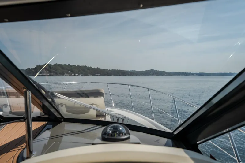 Slide: The Image of View from the helm of a 2012 Regal 42 Sport Coupe on open water. - 33