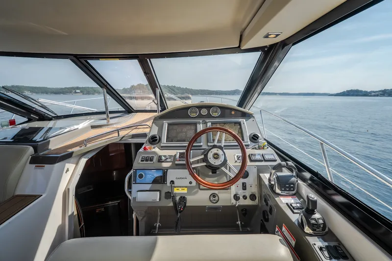 Slide: The Image of Interior view of 2012 Regal 42 Sport Coupe yacht cockpit with steering wheel and controls. - 29
