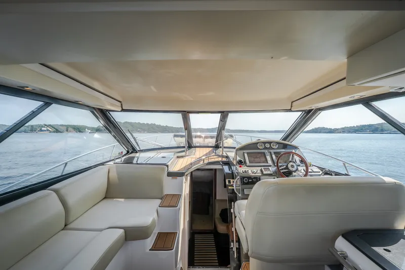 Slide: The Image of Interior view of 2012 Regal 42 Sport Coupe yacht with modern helm and seating. - 23