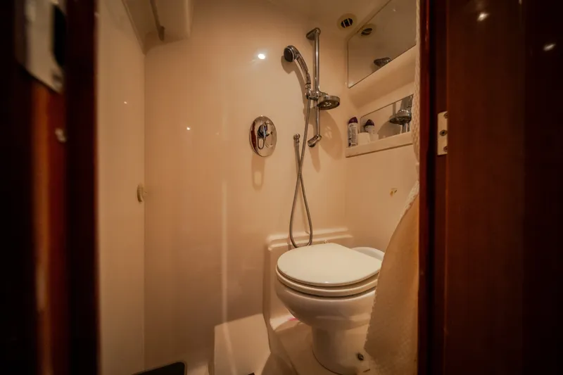 Slide: The Image of Bathroom interior of 2012 Regal 42 Sport Coupe yacht, featuring shower and toilet. - 57