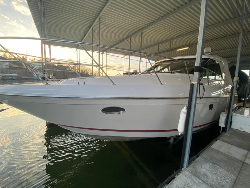 Slide: The Image of 2012 Regal 42 Sport Coupe docked under a covered marina. - 8