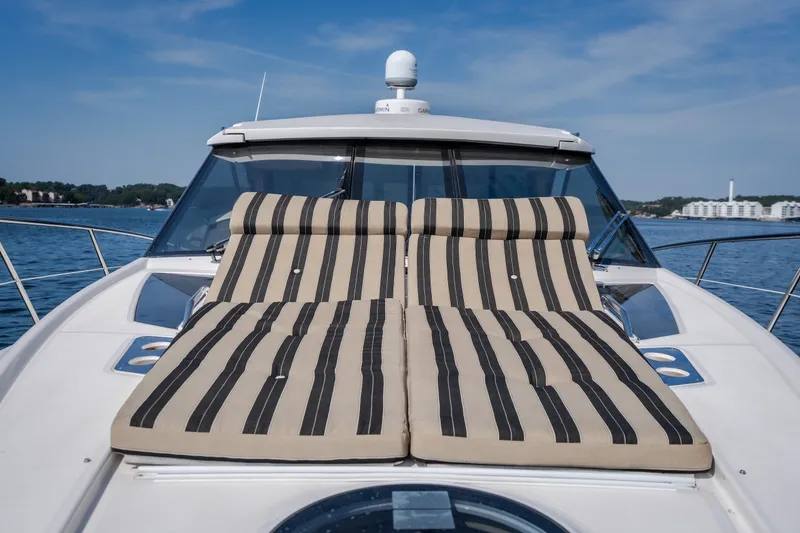 Slide: The Image of 2012 Regal 42 Sport Coupe with striped sun loungers on deck, cruising on a sunny day. - 40
