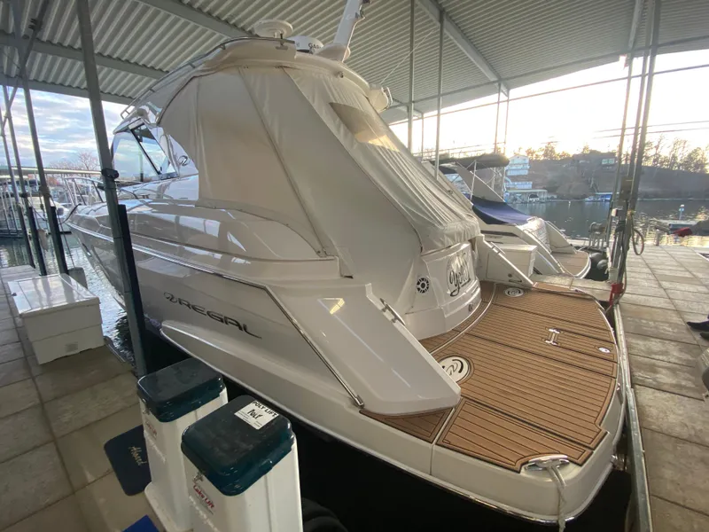 Slide: The Image of 2012 Regal 42 Sport Coupe yacht docked under a covered marina. - 9