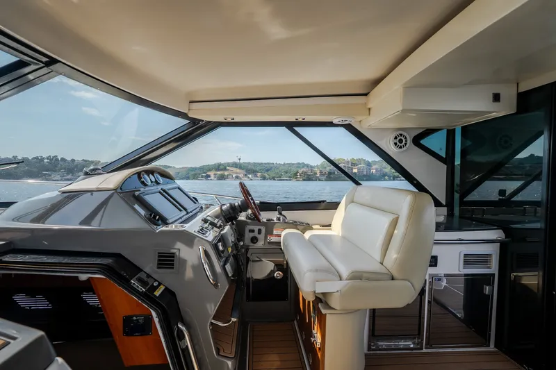 Slide: The Image of Interior of 2012 Regal 42 Sport Coupe yacht with luxurious helm and seating. - 28